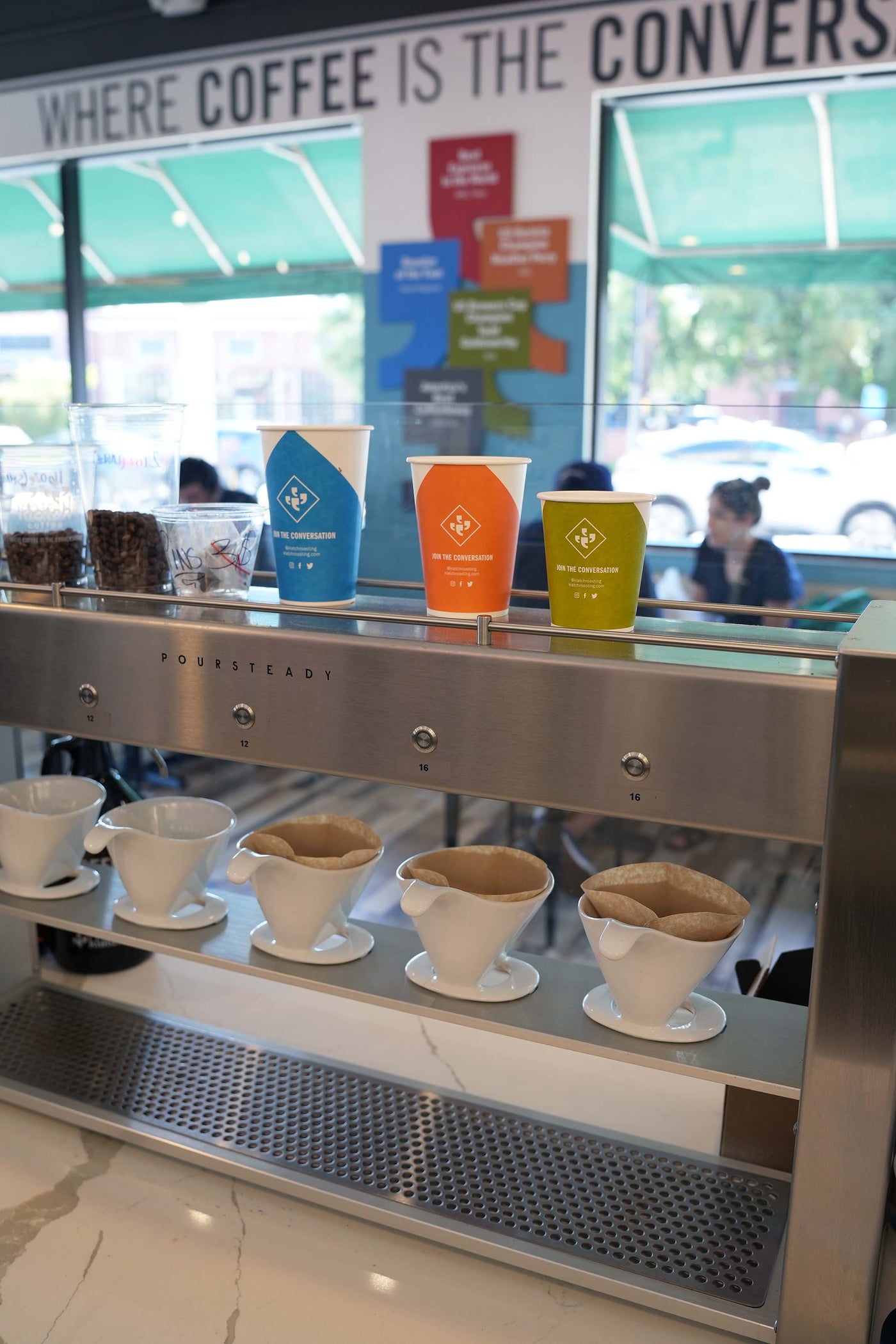 3 coffee cups on a shelf