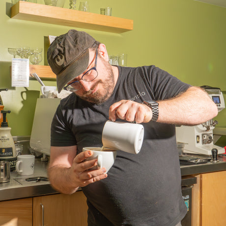 Daniel pouring a latte.