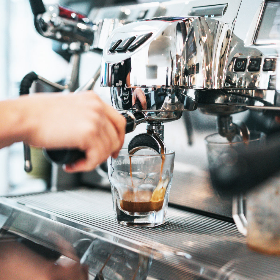 pulling espresso shots from a machine